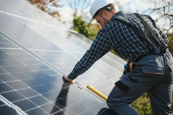 stock image Worker installing solar panels outdoors.