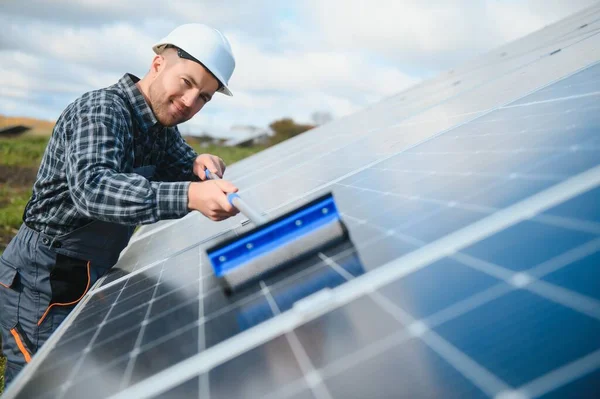 technician operating and cleaning solar panels at generating power of solar power plant technician in industry uniform on level of job description at industrial.