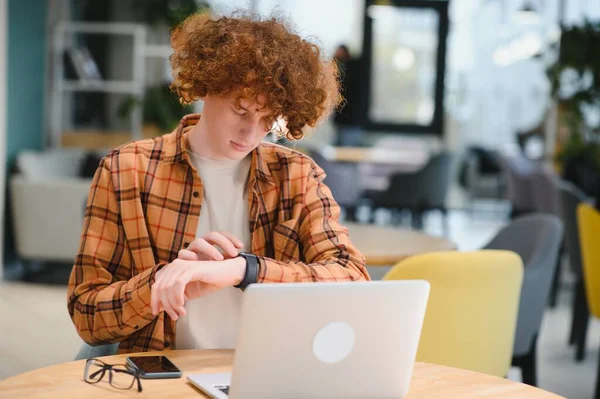 stock image Stylish male freelancer working on new startup project making internet researchers analyzing data using laptop computer and wireless connection to 4G internet in city cafe.