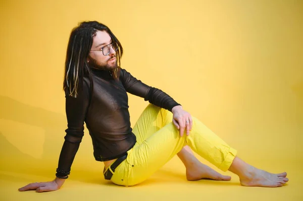 stock image Young gay man is standing in the studio and posing for a camera