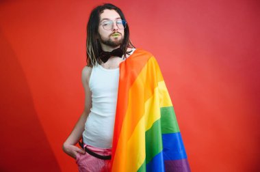 LGBTQ topluluğunun gökkuşağı bayrağı tutan mutlu bir gay..