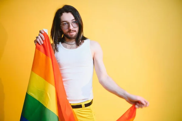 stock image Youth transgender LGBT with Rainbow flag on shoulder isolated color background. gender expression pride and equality concept