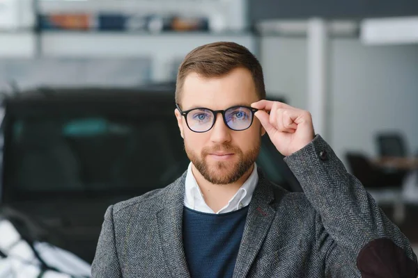 stock image Young man in the car dealership