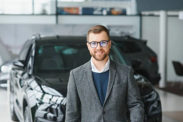 stock image Man minded customer male buyer client in suit choose auto to go look aside want buy new automobile in car showroom