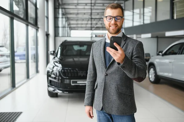 stock image Young man in the car dealership