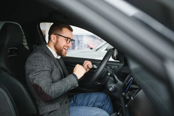 stock image His true love. Portrait of a mature man smiling happily sitting in a brand new car.