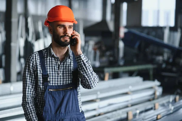 stock image Factory worker measures the metal profile.