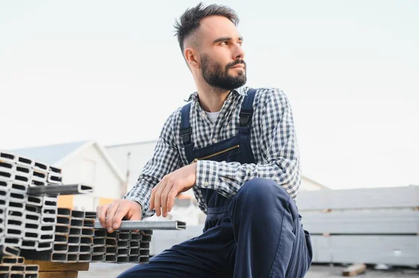 stock image Man chooses metal profile for construction.