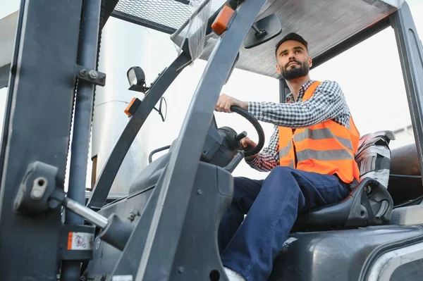 stock image Man working at warehouse and driving forklift.