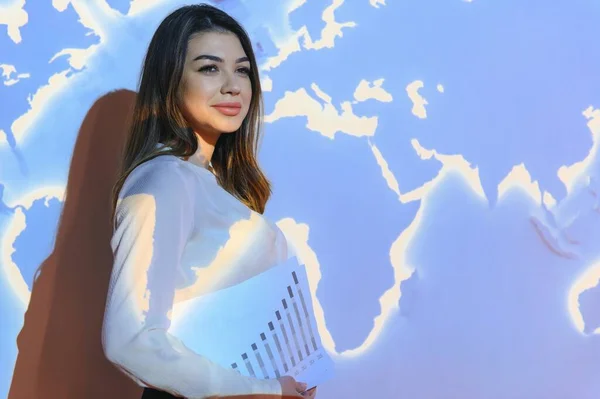 Globe business concept - happy business woman with world map background