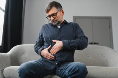 Yaşlı adam evinde sindirim problemleri yaşıyor..