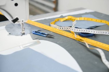 sewing supplies on the table next to the sewing machine.