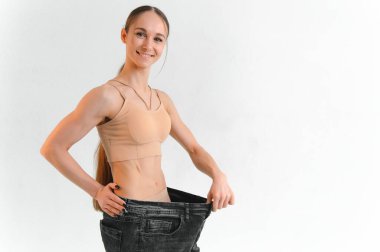 Happy girl showing her slim figure after workout.