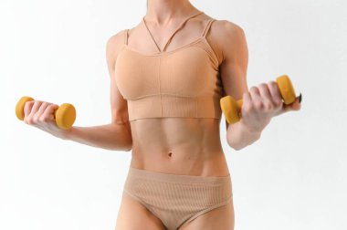 Slim fitness model on a white background. Perfect shape of the female body. Sport, health and diet concept