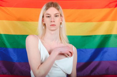 Fashionable young transgender woman on color background.