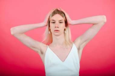 Fashionable young transgender woman on color background.