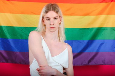 Fashionable young transgender woman on color background.