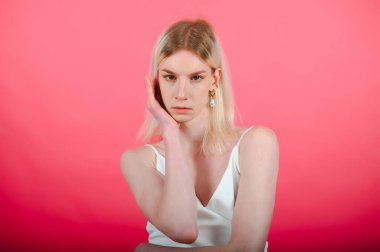 Handsome man wearing make up and woman clothes looking at the camera. positive person