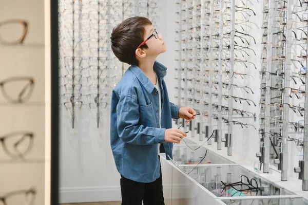 boy in glasses , at optics store.