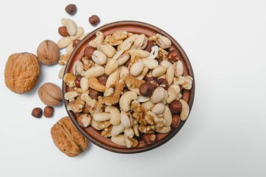 Mixed nuts on a plate. White background.