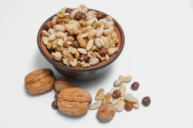 Mixed nuts on a plate. White background.