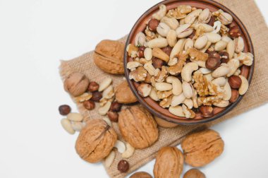 Mixed nuts on a plate. White background.