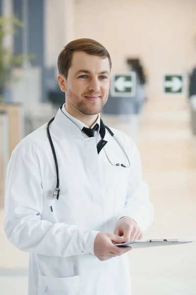Male Doctor stands in the hall of the hospital.