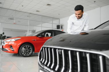 happy indian man buy new biodiesel eco automobile in lux showroom