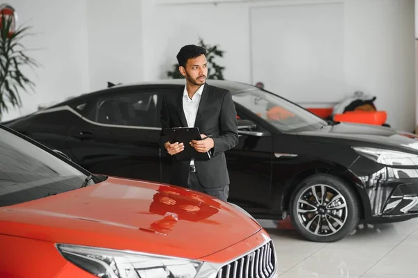 Handsome Indian Salesman Presenting New Car Clients — Foto de Stock