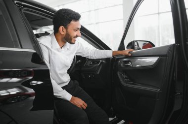 happy indian man buy new biodiesel eco automobile in lux showroom