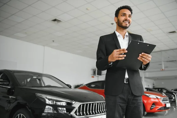 stock image indian cheerful car salesman at showroom