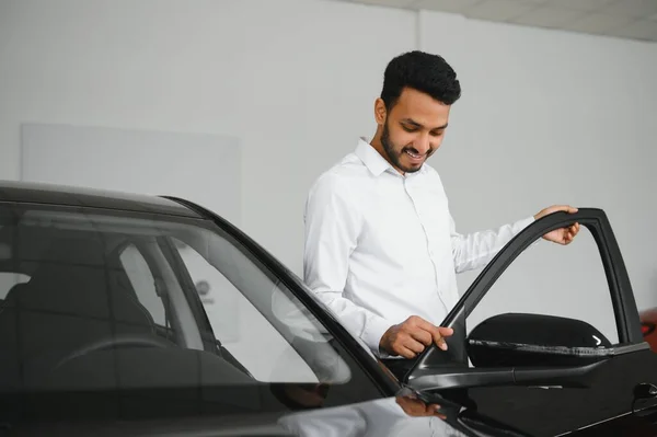 Happy Indian Man Checking Car Features Showroom — Stockfoto