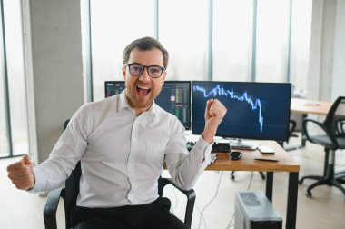 Successful trader in formalwear checking cryptocurrency information data on finance market graph, working in office.