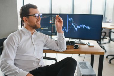 Successful trader in formalwear checking cryptocurrency information data on finance market graph, working in office.