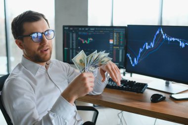 Holding Dollar bills in the stock market. Investors counting money after making it big on the stock market. becoming rich and wealthy. online stock market information