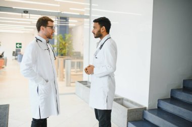 an Indian doctor with a European doctor colleague. Multiracial team concept.