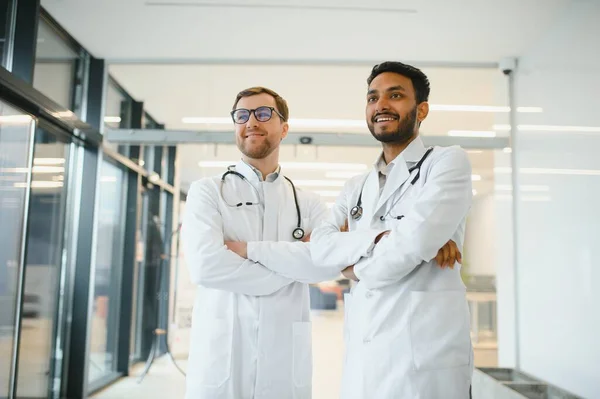 an Indian doctor with a European doctor colleague. Multiracial team concept.