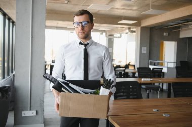 business, firing and job loss concept - fired male office worker with box of his personal stuff