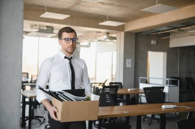 business, firing and job loss concept - fired male office worker with box of his personal stuff