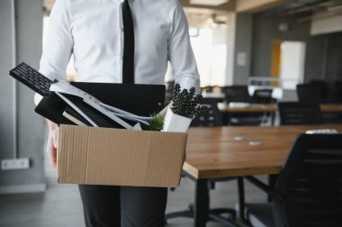 Ofis Toplantısı sırasında karton kutu taşıyan bir iş adamının yakın çekimi.
