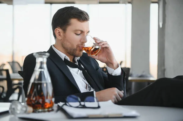 stock image Businessman drinking from stress at workplace.