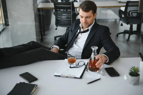 stock image Young businessman drinking from stress.