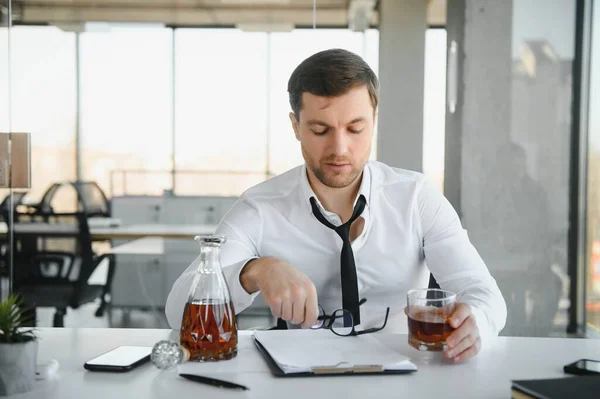 stock image Businessman drinking from stress at workplace.