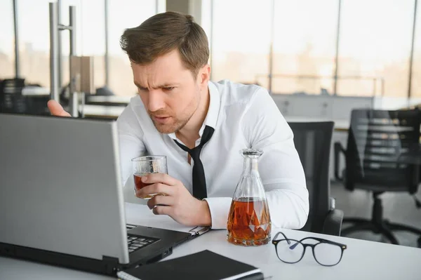 Fatigue Young Businessman Sitting Workplace Holding Whiskey Bottle Drinking Alcohol — Zdjęcie stockowe