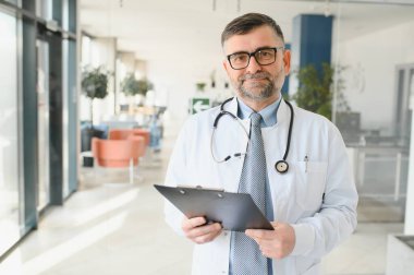 portrait of a senior doctor in his office in a hospital.