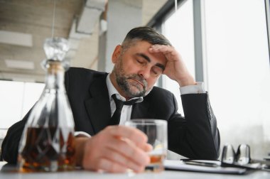 Alkolizm iş başında. İş yerinde alkol tüketmekten yorulmuş, stresle başa çıkamıyor..