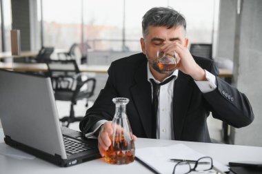 İş yerinde alkol alan yaşlı bir erkek işçi..