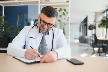 portrait of a senior doctor in his office in a hospital.