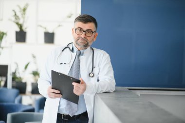 portrait of a senior doctor in his office in a hospital.