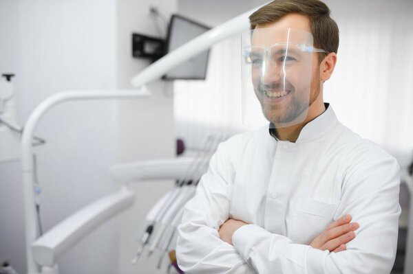 Young male dentist in clinic.